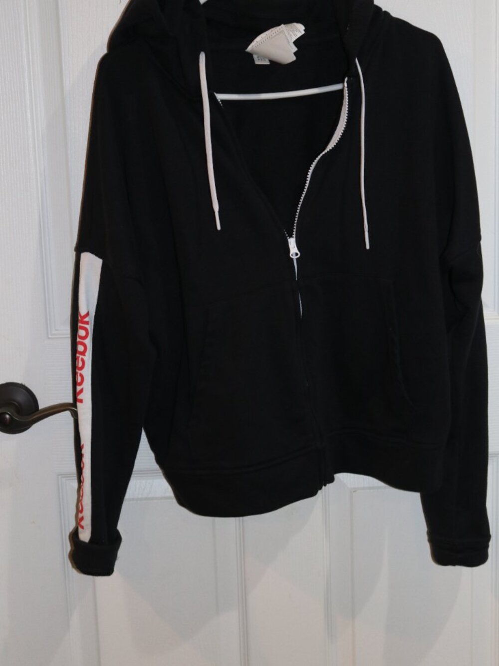 Women's black and white Reebok zip up hooded sweatshirt. New. Large.